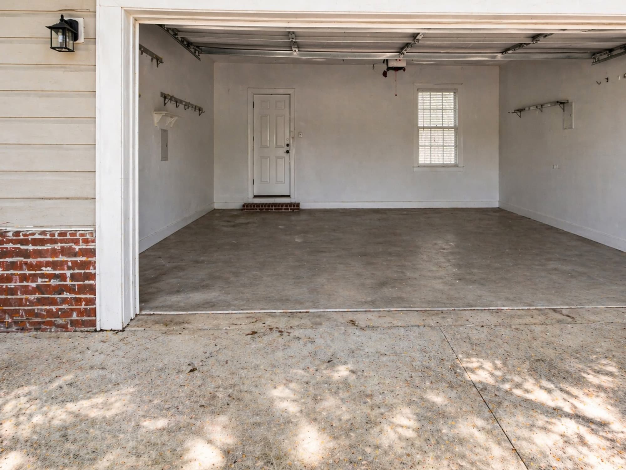 Same Brunswick garage after cleanout by Golden Isles Junk Removal, cleared and swept.