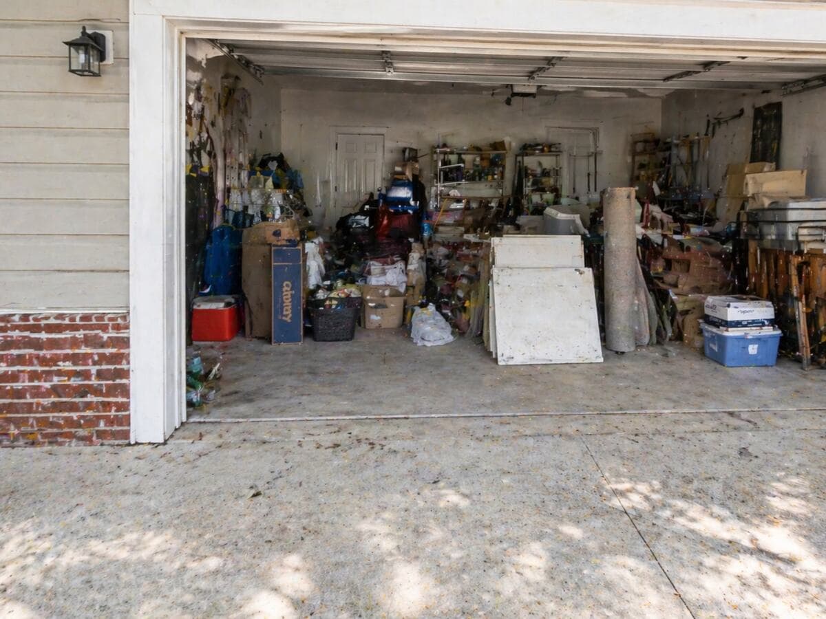 A Brunswick, Georgia residential garage before Golden Isles Junk Removal crew cleared it out.