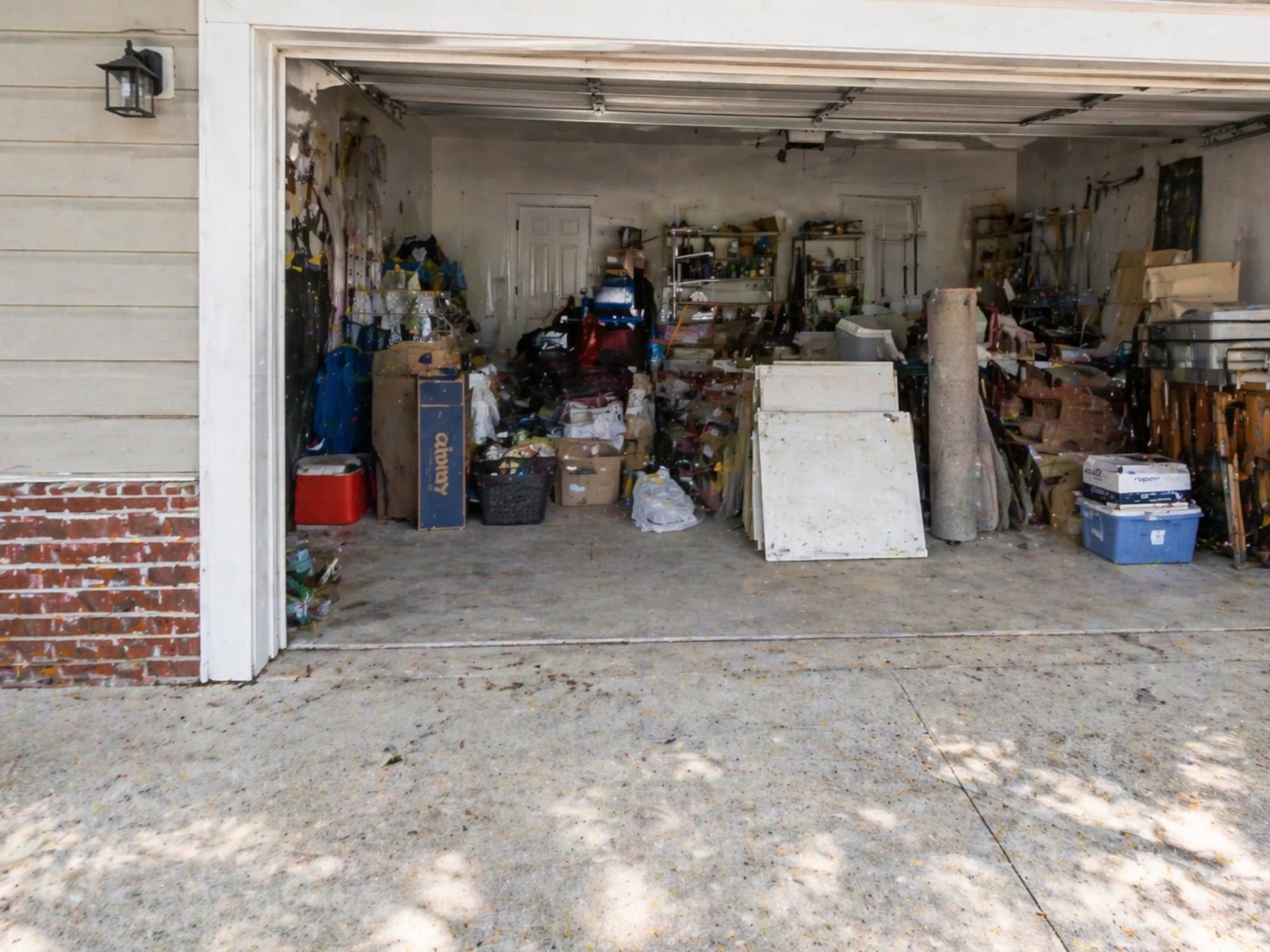 A Brunswick, Georgia residential garage before Golden Isles Junk Removal crew cleared it out.