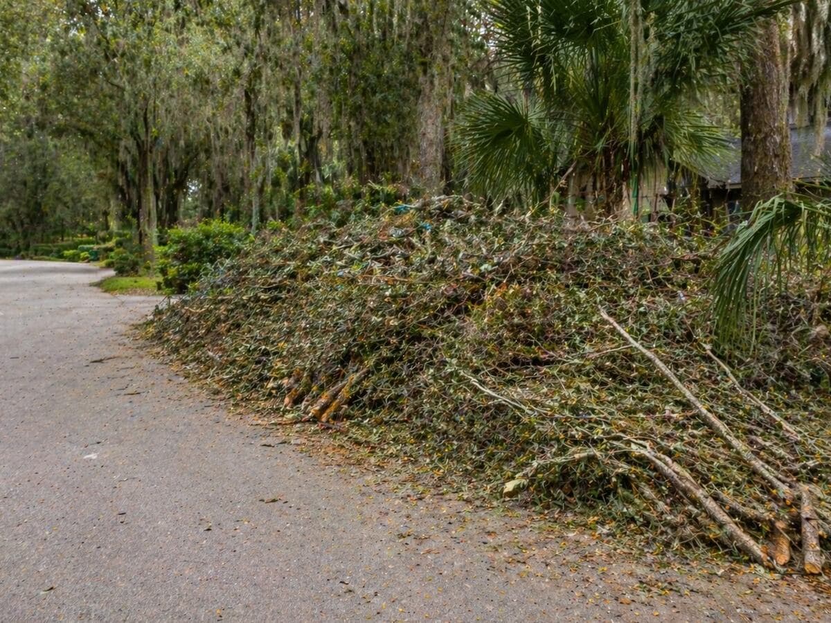Post-storm debris in a Jekyll Island, Georgia yard before cleanup by Golden Isles Junk Removal.